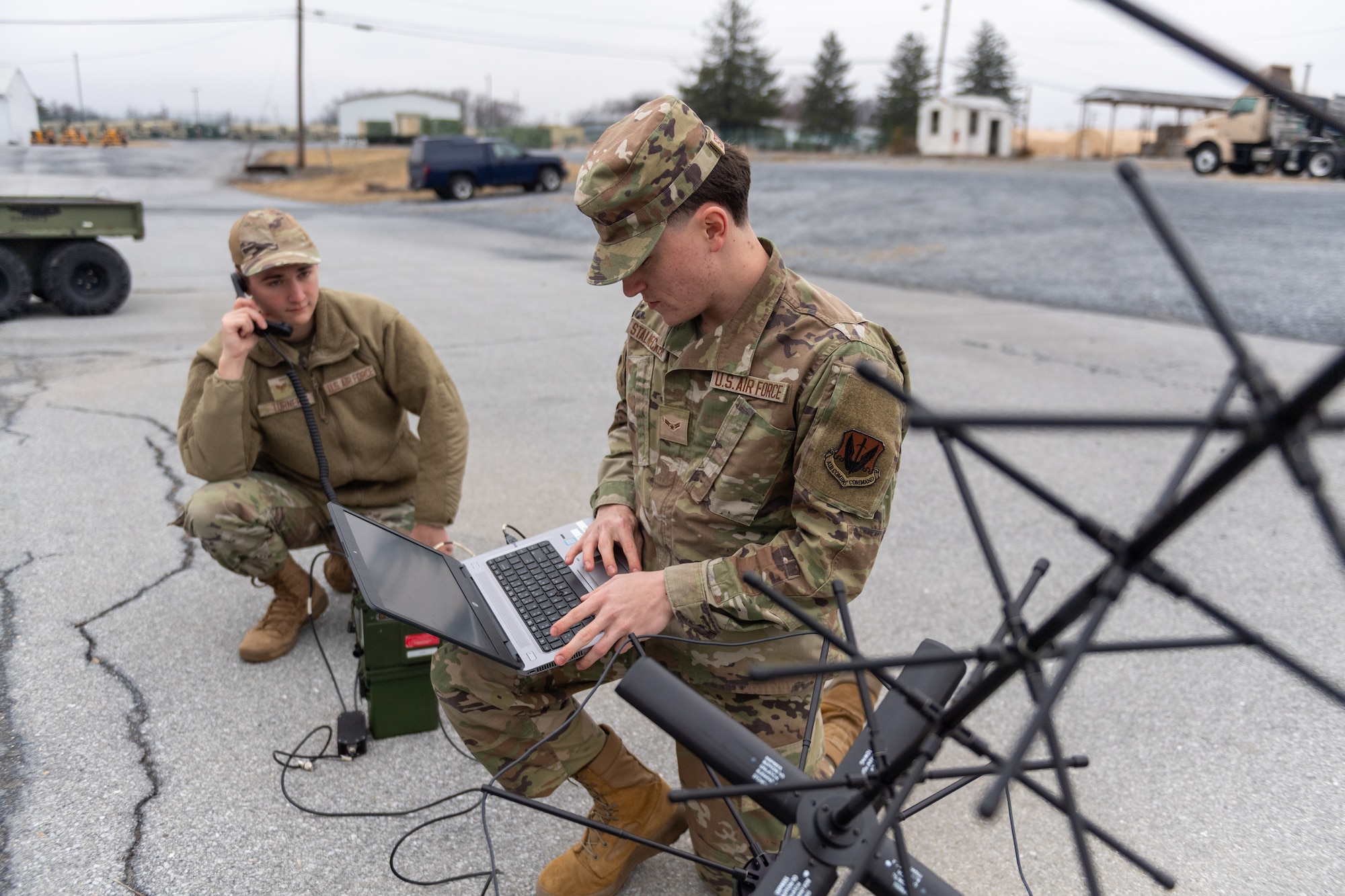 Staff Sgt. Ethan Turner (left) and Airman 1st Class Benjamin Stalnecker, radio frequency transmission systems specialists with the 271st Combat Communications Squadron, assemble an AV2040 high-gain ultra high frequency satellite communications antenna connected to an AN/PRC-117G multiband networking radio which enables secure voice and data communications through a geostationary satellite for the warfighter, March 15, 2025.