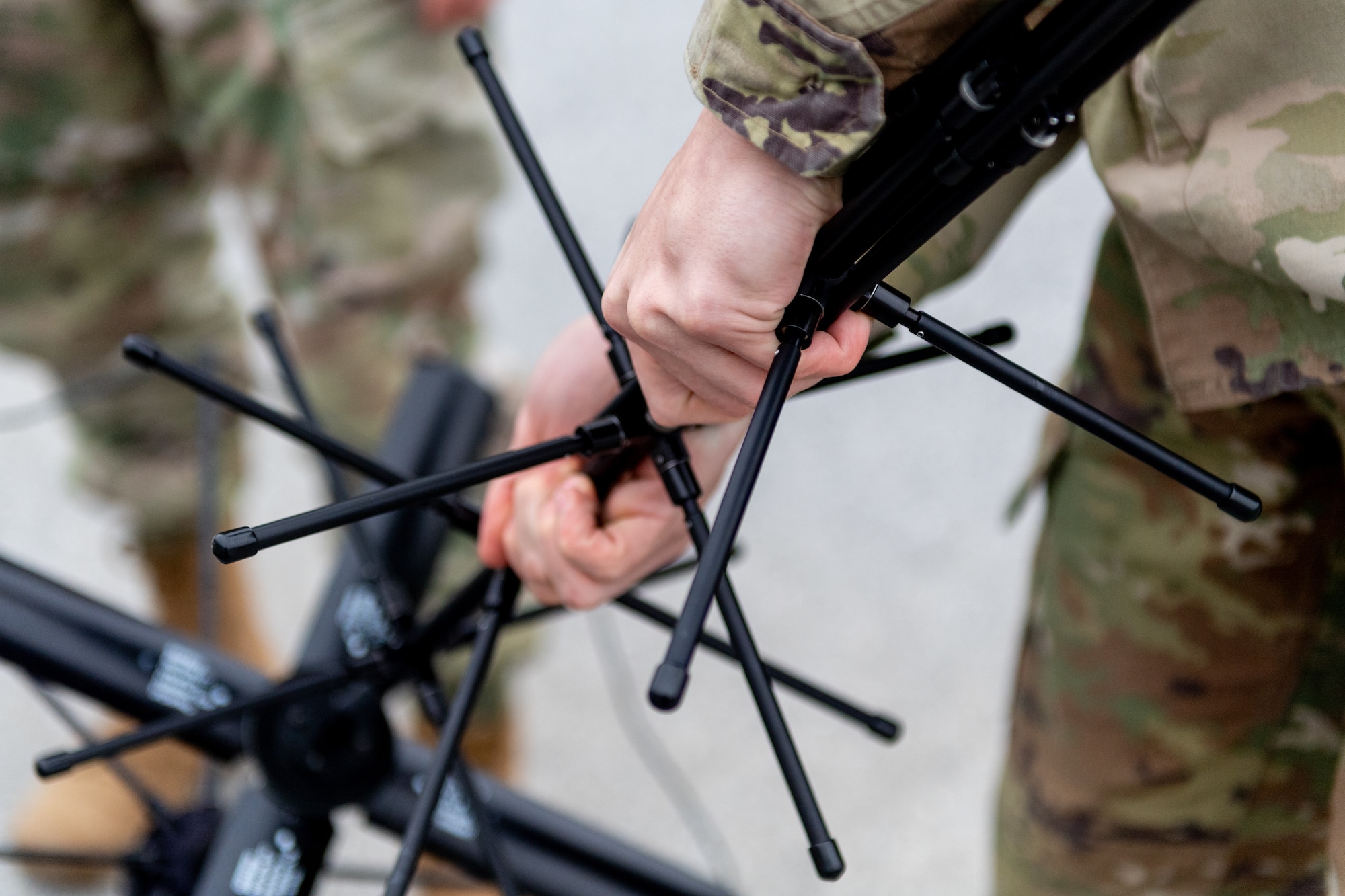 Radio frequency transmission systems specialists with the 271st Combat Communications Squadron assemble an AV2040 high-gain ultra high frequency satellite communications antenna connected to an AN/PRC-117G multiband networking radio which enables secure voice and data communications through a geostationary satellite for the warfighter, March 15, 2025.