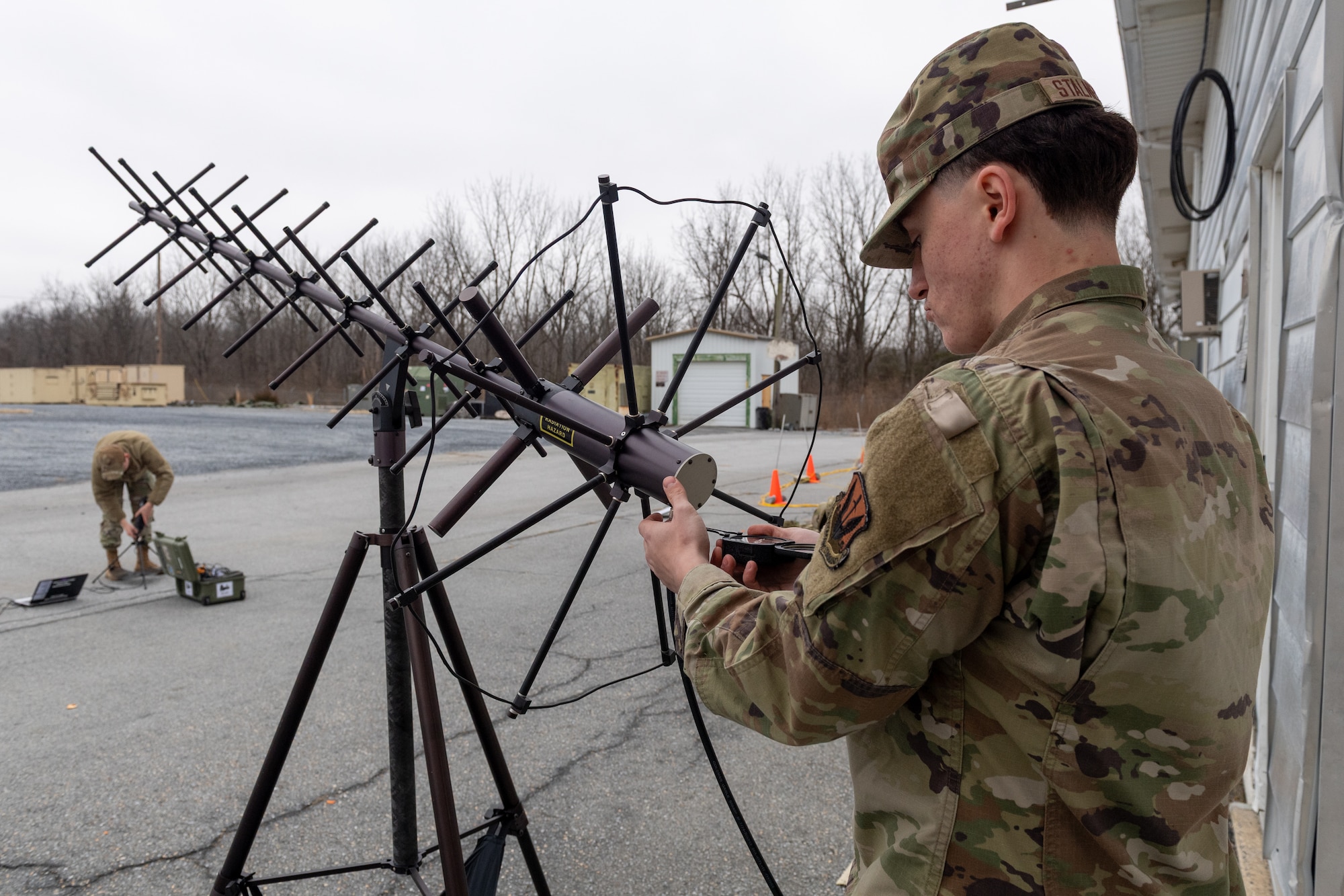 Airman 1st Class Benjamin Stalnecker, radio frequency transmission systems specialist with the 271st Combat Communications Squadron, aligns an AV2011 high-gain ultra high frequency satellite communications antenna with a pocket transit during weekend drill training, March 15, 2025.