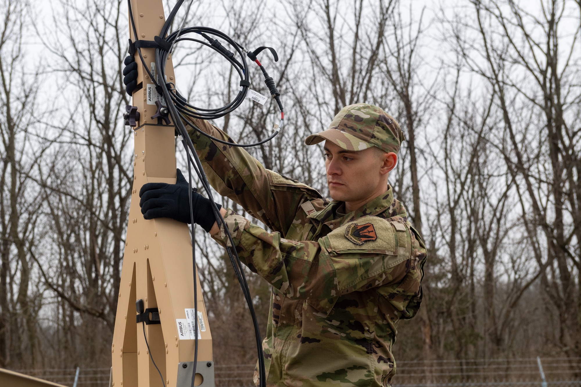 Airman 1st Class Elijah Allison, radio frequency transmission systems specialist with the 271st Combat Communications Squadron, repositions an Airbus Ranger 2400 satellite antenna due to projected severe weather, March 15, 2025.