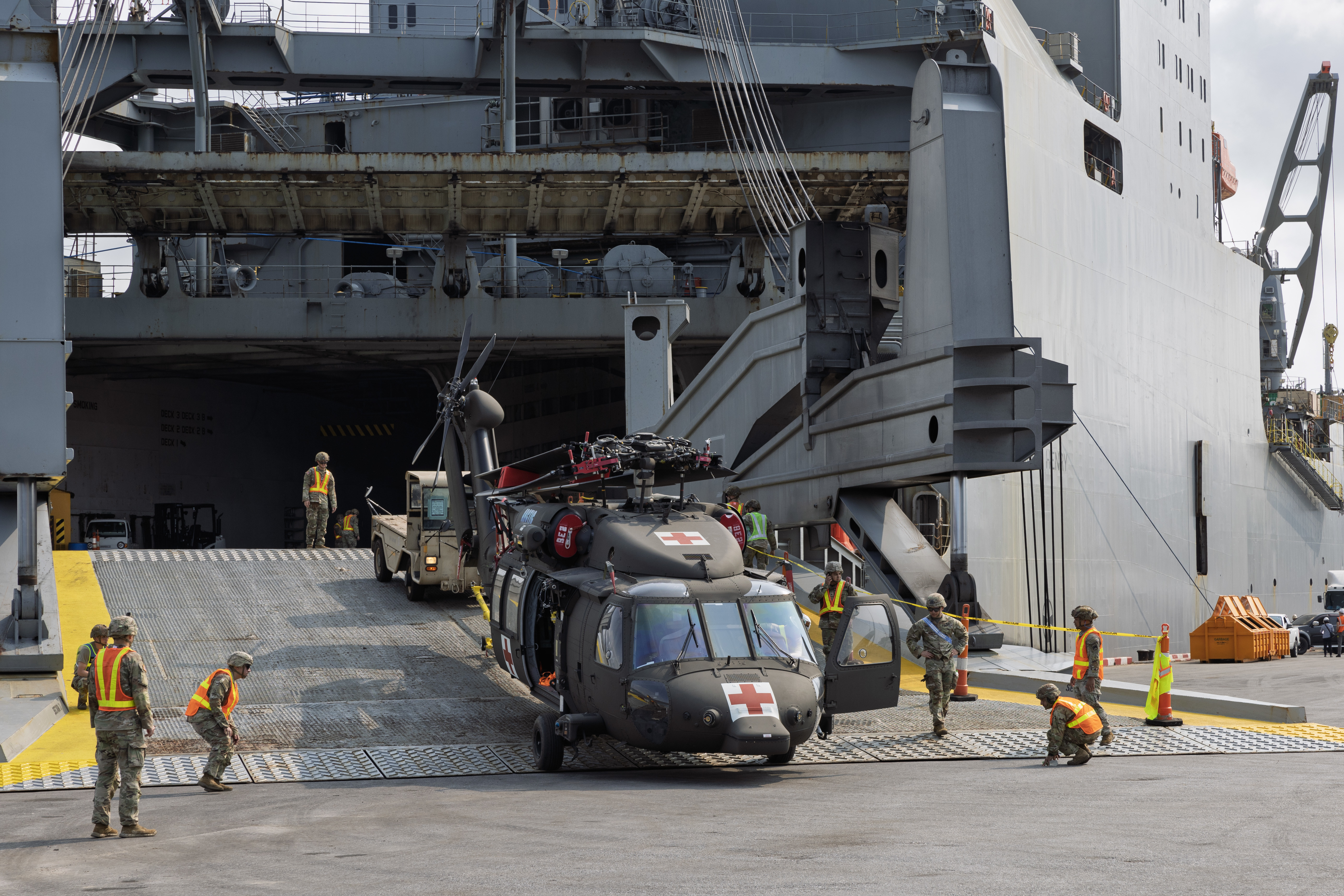A UH-60 Black Hawk helicopter is discharged from Military Sealift Command (MSC) chartered Motor Vessel Cape Henry (T-AKR 5067) at the pier in Sattahip, Thailand, Feb. 18, during an offload of equipment that will be used in Joint Exercise Cobra Gold 2025.