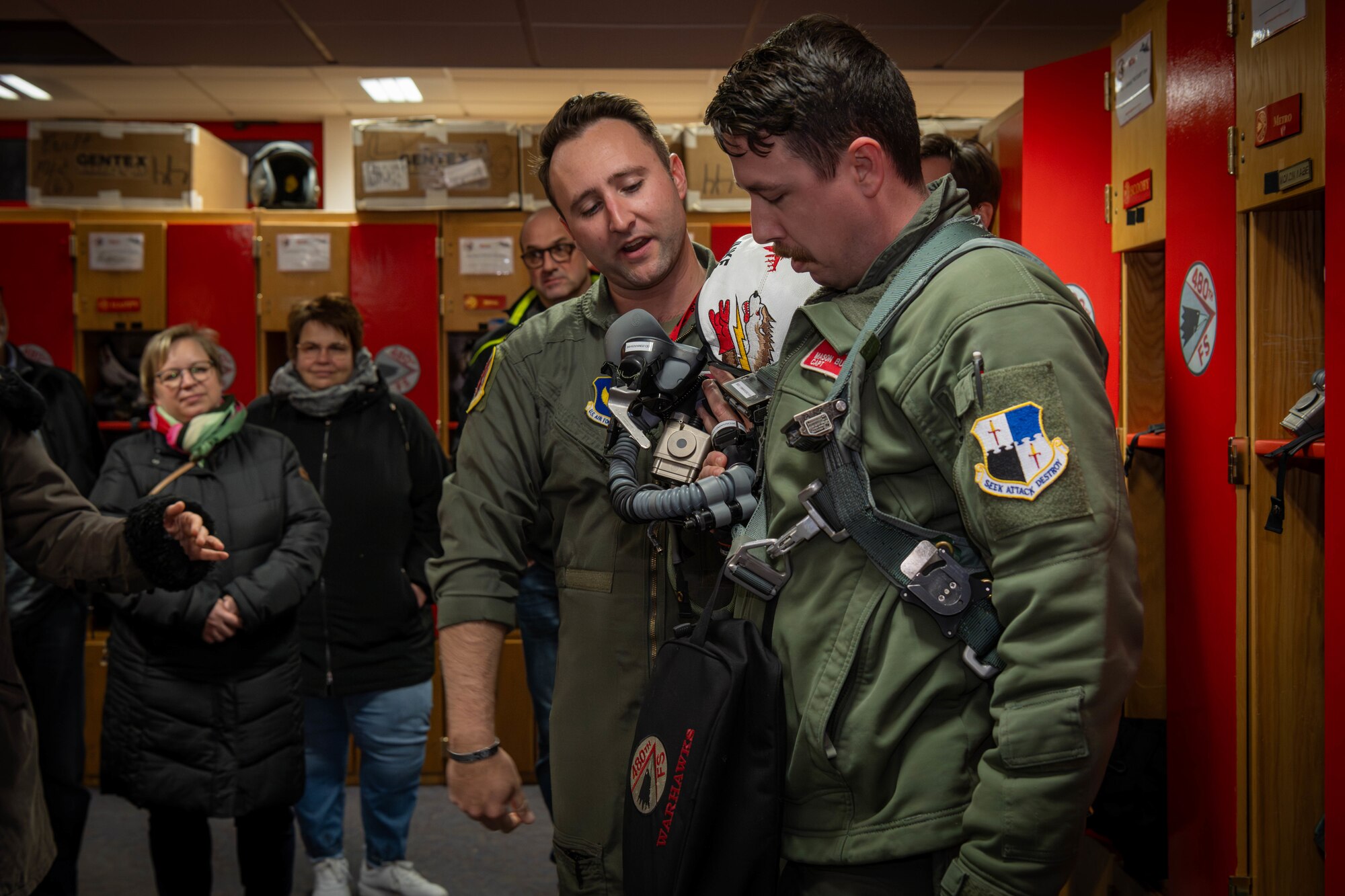 Two Air Force pilots discuss components of the helmets they wear when flying an F-16 Fighting Falcon.