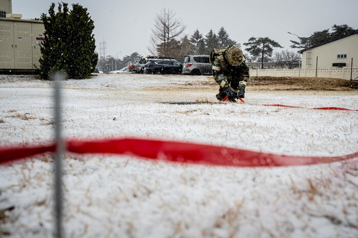 Airman cordons off an area