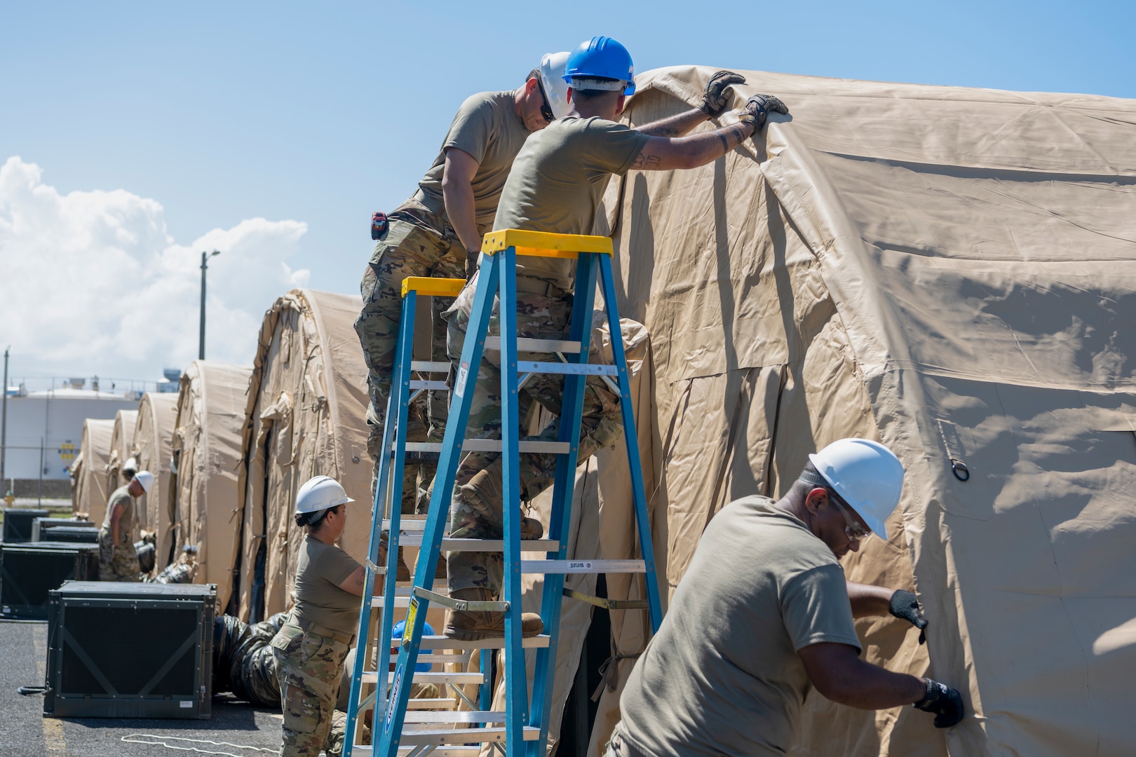 U.S. Airmen assigned to the 156th Civil Engineer Squadron, Puerto Rico Air National Guard, secure a tent outer tarp during a Disaster Relief Beddown System build up at Muñiz Air National Guard Base, Carolina, Puerto Rico, Feb. 27, 2025. The 156th CES Airmen assembled the DRBS, which can shelter 150 people in case of a disaster, as a training opportunity in preparation for the March regularly scheduled drill.