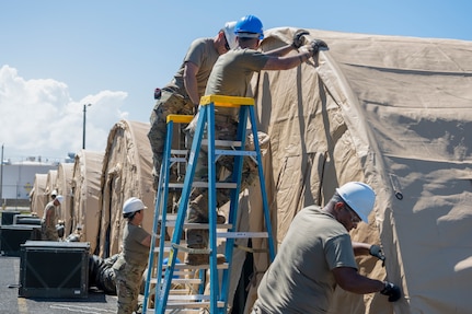 U.S. Airmen assigned to the 156th Civil Engineer Squadron, Puerto Rico Air National Guard, secure a tent outer tarp during a Disaster Relief Beddown System build up at Muñiz Air National Guard Base, Carolina, Puerto Rico, Feb. 27, 2025. The 156th CES Airmen assembled the DRBS, which can shelter 150 people in case of a disaster, as a training opportunity in preparation for the March regularly scheduled drill.