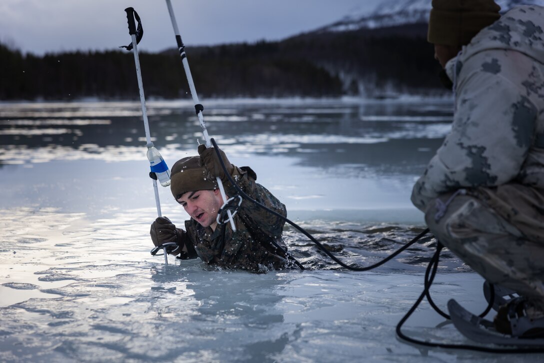 A U.S. Marine with Combat Logistics Battalion 2, Combat Logistics Regiment 2, 2nd Marine Logistics Group participates in an ice breakthrough event in preparation of Exercise Joint Viking 25 in Setermoen, Norway, Feb. 7, 2025. U.S. Marines are in Norway as part of Exercise Joint Viking 25, a Norwegian military exercise focusing on arctic cold-weather training and military-to-military engagements. The exercise demonstrates the Marine Corps' unique ability to rapidly deploy during a crisis and aims to enhance interoperability between the U.S. Marine Corps and NATO allies and partners. (U.S. Marine Corps photo by Sgt. Antonino Mazzamuto)