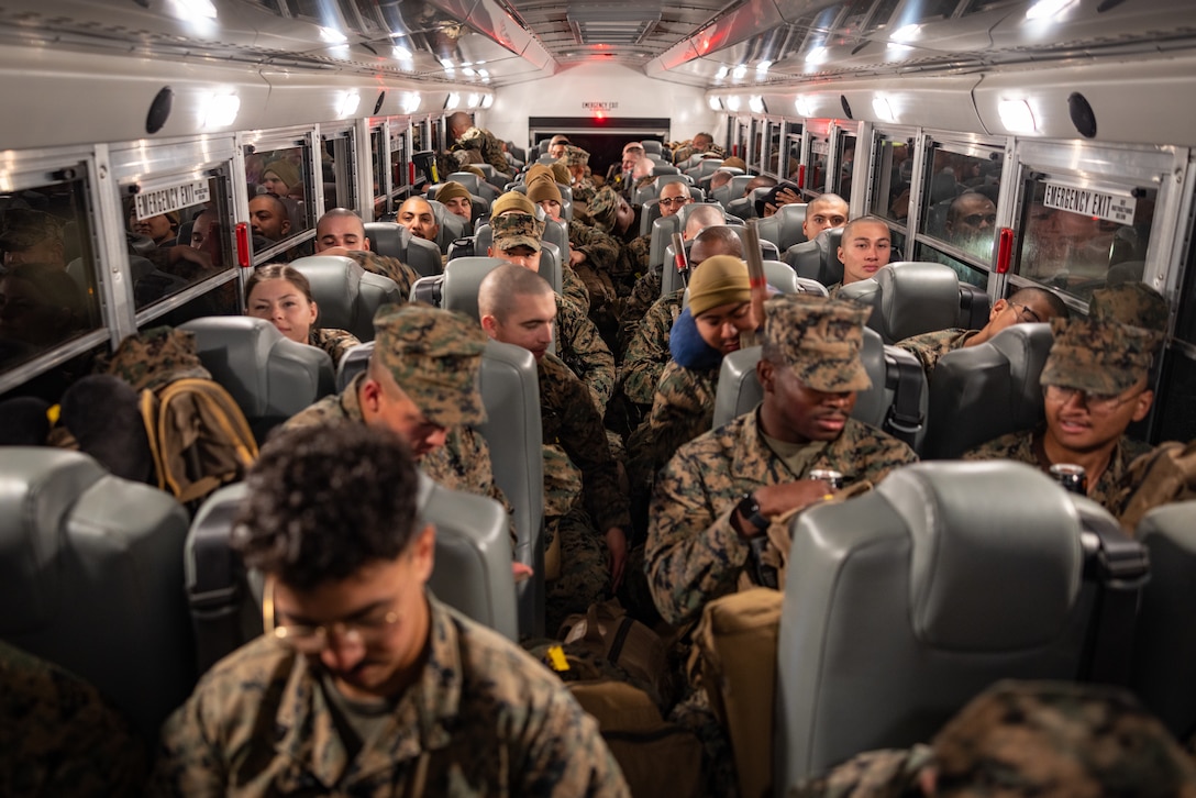 U.S. Marines with 2nd Battalion, 23rd Marines, 4th Marine Division, Marine Forces Reserve, sit in a bus on Marine Air Ground Combat Center Twentynine Palms, California, March 11, 2025.The Marines are headed to Kadena Air Base, Okinawa, Japan as part of Unit Deployment Program 25.1. The activation marks the beginning of an intensive period of training for 2nd Battalion, 23rd Marines as they provide a total force solution in support of the UDP by aligning Marine Forces Reserve’s commitment to Marine Corps strategic objectives. This is first time since 2020 that an entire Reserve infantry battalion has activated to support the Unit Deployment Program. (U.S. Marine Corps photo by Sgt. Scott Jenkins)