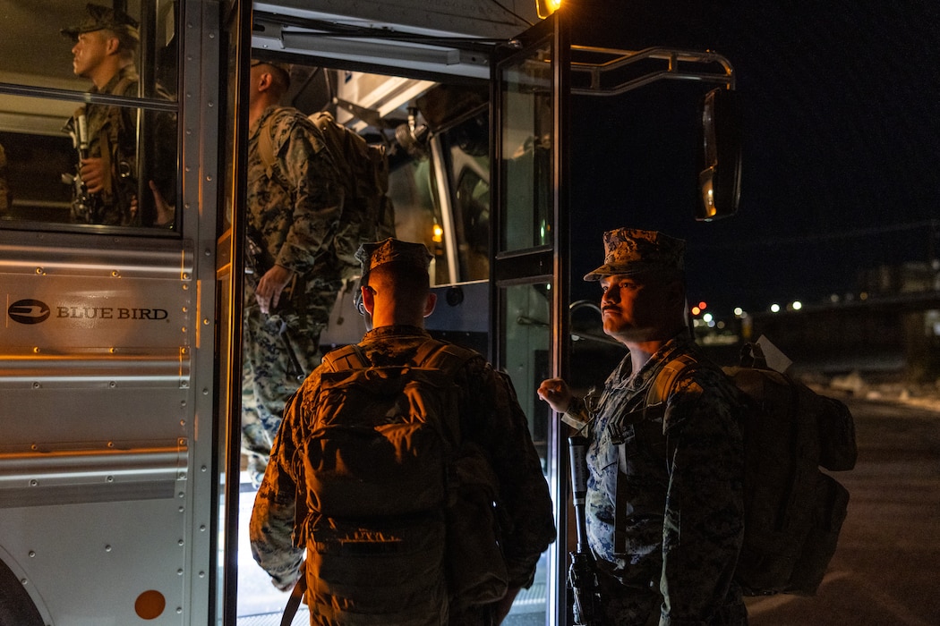 U.S. Marine Corps Staff Sgt. Ezequiel Delatorre, a network chief, with Headquarters and Service Company,  2nd Battalion, 23rd Marines, 4th Marine Division, Marine Forces Reserve, and a native of Oxnard California, counts Marines as they walk into a bus on Marine Air Ground Combat Center Twentynine Palms, California, March 11, 2025.The Marines are headed to Kadena Air Base, Okinawa, Japan as part of Unit Deployment Program 25.1. The activation marks the beginning of an intensive period of training for 2nd Battalion, 23rd Marines as they provide a total force solution in support of the UDP by aligning Marine Forces Reserve’s commitment to Marine Corps strategic objectives. This is first time since 2020 that an entire Reserve infantry battalion has activated to support the Unit Deployment Program. (U.S. Marine Corps photo by Sgt. Scott Jenkins)