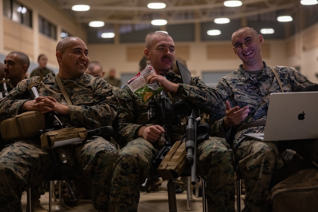 U.S. Marine Corps Sgt Anthony Giron, left, an infantryman and native of Los Angeles, California, Lance Cpl. Kagan Begley, center, a chemical, biological, radiological, and nuclear defense specialist and Native of Sacramento, California, and Cpl Haunter Hernandezescobedo, an infantryman and native of East Vale, California, watch a movie together while waiting in a passenger terminal at March Air Reserve Base, California, March 12, 2025.The Marines are headed to Kadena Air Base, Okinawa, Japan as part of Unit Deployment Program 25.1. The activation marks the beginning of an intensive period of training for 2nd Battalion, 23rd Marines as they provide a total force solution in support of the UDP by aligning Marine Forces Reserve’s commitment to Marine Corps strategic objectives. This is first time since 2020 that an entire Reserve infantry battalion has activated to support the Unit Deployment Program. (U.S. Marine Corps photo by Sgt. Scott Jenkins)