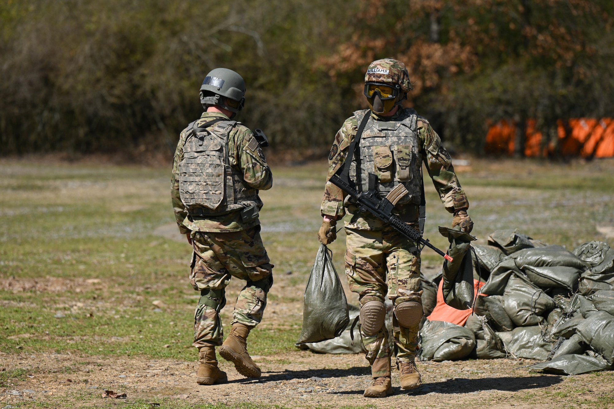 Two men carry bags.