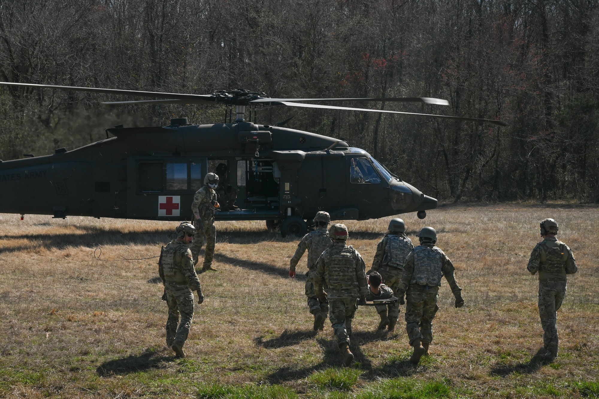 Men walk towards helicopter.
