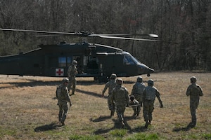 Men walk towards helicopter.