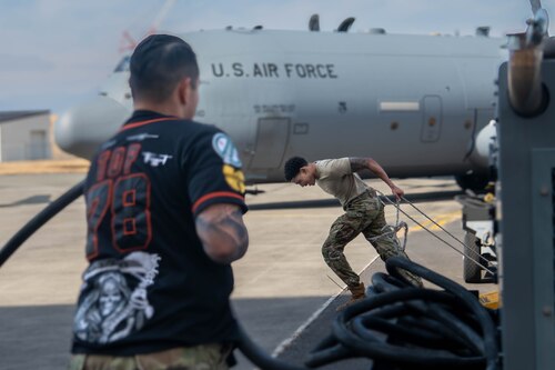 U.S. Air Force Senior Airman Daiquan Baskin, 374th Aircraft Maintenance Squadron flying crew chief, pulls aircraft chocks.