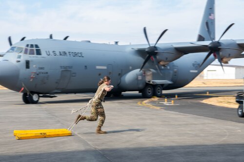 U.S. Air Force Airman 1st Class Sidney Woodhouse, 374th Aircraft Maintenance Squadron crew chief, drags aircraft wheel chocks.
