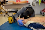 250303-N-KC192-1140 SPRING LAKE, N.C. (Mar. 3, 2025) - Hospital Corpsman 1st Class Axel Narvaez, the regional training officer assigned to Naval Medical Forces Atlantic (NMFL),  checks the airway breathing of a simulated patient during a training scenario during a paramedic training scenario at Fayetteville Technical Community College, Mar. 3, 2025. The primary purpose of the 20-week joint military paramedic course at Fayetteville Technical Community College in Spring Lake, North Carolina is to expand the skills of service members, and increase survivability of those in harm’s way. Navy Medicine is enhancing Expeditionary Medical Unit (EXMED) capabilities by equipping Hospital Corpsmen with advanced trauma and pre-hospital care skills through an accelerated paramedic training program. This intensive five-month course ensures corpsmen are prepared to deliver life-sustaining care in austere environments, strengthening the Navy’s ability to support warfighters in operational settings worldwide. (U.S. Navy photo by Mass Communication Specialist 2nd Class Levi Decker)