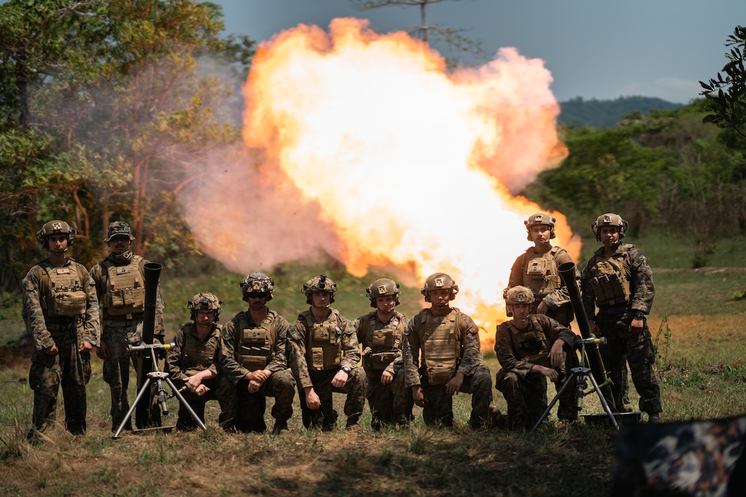 U.S. Marines with 1st Light Armored Reconnaissance Battalion, attached to Marine Rotational Force-Southeast Asia, pose for a photo while disposing of mortar increments during the Marine final exercise at Ban Chan Khrem, Chanthaburi, Thailand, March 6, 2025, during Exercise Cobra Gold 2025. Cobra Gold is the largest joint and combined exercise in mainland Asia, held annually in Thailand, showcasing the U.S. commitment to the region by building interoperability, multilateral cooperative arrangements, and advancing common interests through a commitment to allies and partners in ensuring a free and open Indo-Pacific. MRF-SEA is a rotational unit derived from elements of I MEF executing a U.S. Marine Corps Forces, Pacific operational model that involves training events and exchanges with partner military subject matter experts, promotes security goals with allied and partner nations, and ensures a persistent I MEF stand-in presence west of the international date line. (U.S. Marine Corps photo by Sgt. Shaina Jupiter)