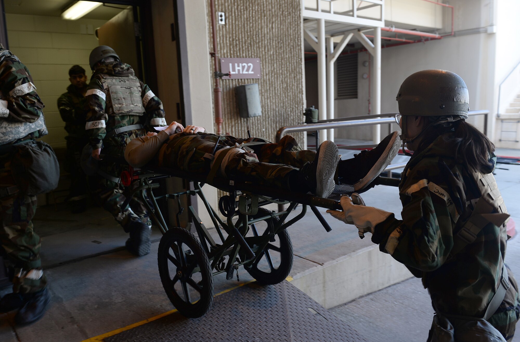 U.S. Air Force medics transport a simulated casualty to the 51st Medical Group Urgent Care Center during Freedom Shield 25 at Osan Air Base, Republic of Korea, Mar. 11, 2025. Freedom Shield 25 is a defense-oriented exercise focused on fortifying response capabilities to safeguard security on the peninsula. Transporting an injured person after performing tactical combat casualty care is a regularly practiced process during recurring exercises at Osan. (U.S. Air Force photo by Master Sgt. Jerilyn Quintanilla)