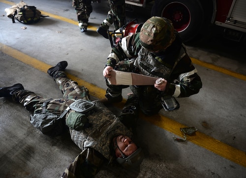 A U.S. Air Force medic assigned to the 51st Fighter Wing applies a bandage to a simulated casualty during Freedom Shield 25 at Osan Air Base, Republic of Korea, Mar. 11, 2025. Service members assigned to the 51st Fighter Wing practiced administering tactical combat casualty care procedures during several simulated mass casualty scenarios, reinforcing time sensitive life-saving skills required for combined defense and air power generation capabilities. A core training objective during FS25 is de-escalation and employment of Armistice mechanisms to provide off-ramps to conflict. (U.S. Air Force photo by Master Sgt. Jerilyn Quintanilla)