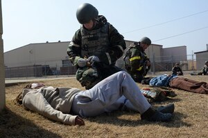 U.S. Air Force Airmen assigned to the 51st Fighter Wing provide tactical combat casualty care to simulated casualties during Freedom Shield 25 at Osan Air Base, Republic of Korea, Mar. 11, 2025. The life-saving TCCC procedures can be rendered by any service member, to onesself or one another, when injuries are sustained in a combat environment. During Freedom Shield 25, units across Seventh Air Force validated several agile combat employment capabilities, illustrating the air component’s ability to maneuver forces and supplies rapidly, projecting and sustaining airpower from numerous locations across the region. (U.S. Air Force photo by Master Sgt. Jerilyn Quintanilla)