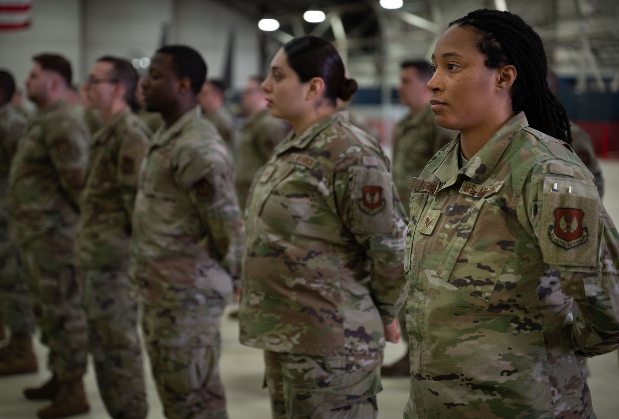 Airmen stand shoulder to shoulder.