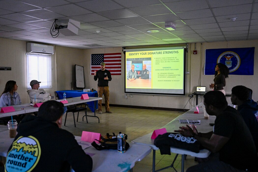 Two students speak in front of a class.