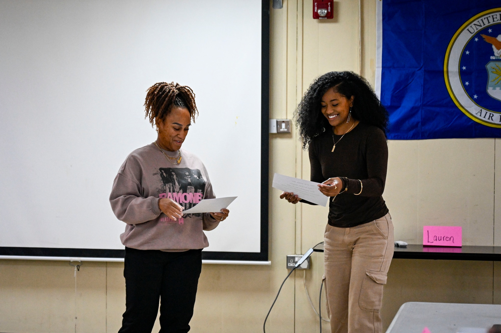 Two people standing holding a certification.