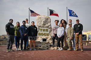 Eleven people pose for a photo.