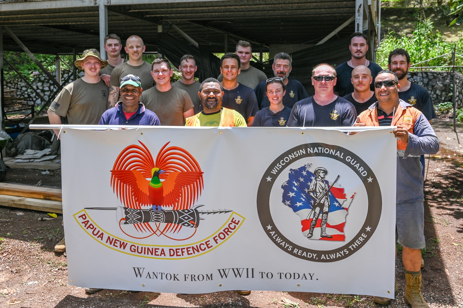 Service members assigned to the 829th Engineer Vertical Construction Company, 724th Engineer Battalion, 157th Mobilization Enhancement Brigade, Wisconsin National Guard; the 65th Air Base Recovery Squadron, Royal Australian Air Force, and the Papua New Guinea Defence Force, pose for a photo at the PNGDF Air Transport Wing in Port Moresby, Papua New Guinea March 13, 2025. The Wisconsin National Guard and Papua New Guinea are State Partnership Program partners.