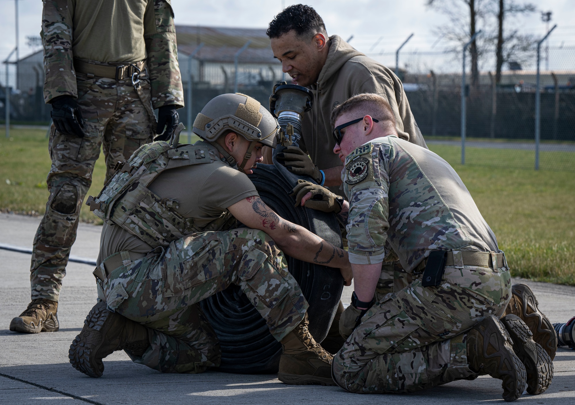 U.S. Air Force Airman 1st Class Sydney Herrera, left, 100th Logistics Readiness Squadron fuels distribution operator, grasps a fuel hose during a forward area refueling point team tryout at RAF Mildenhall, England, March 14, 2025.