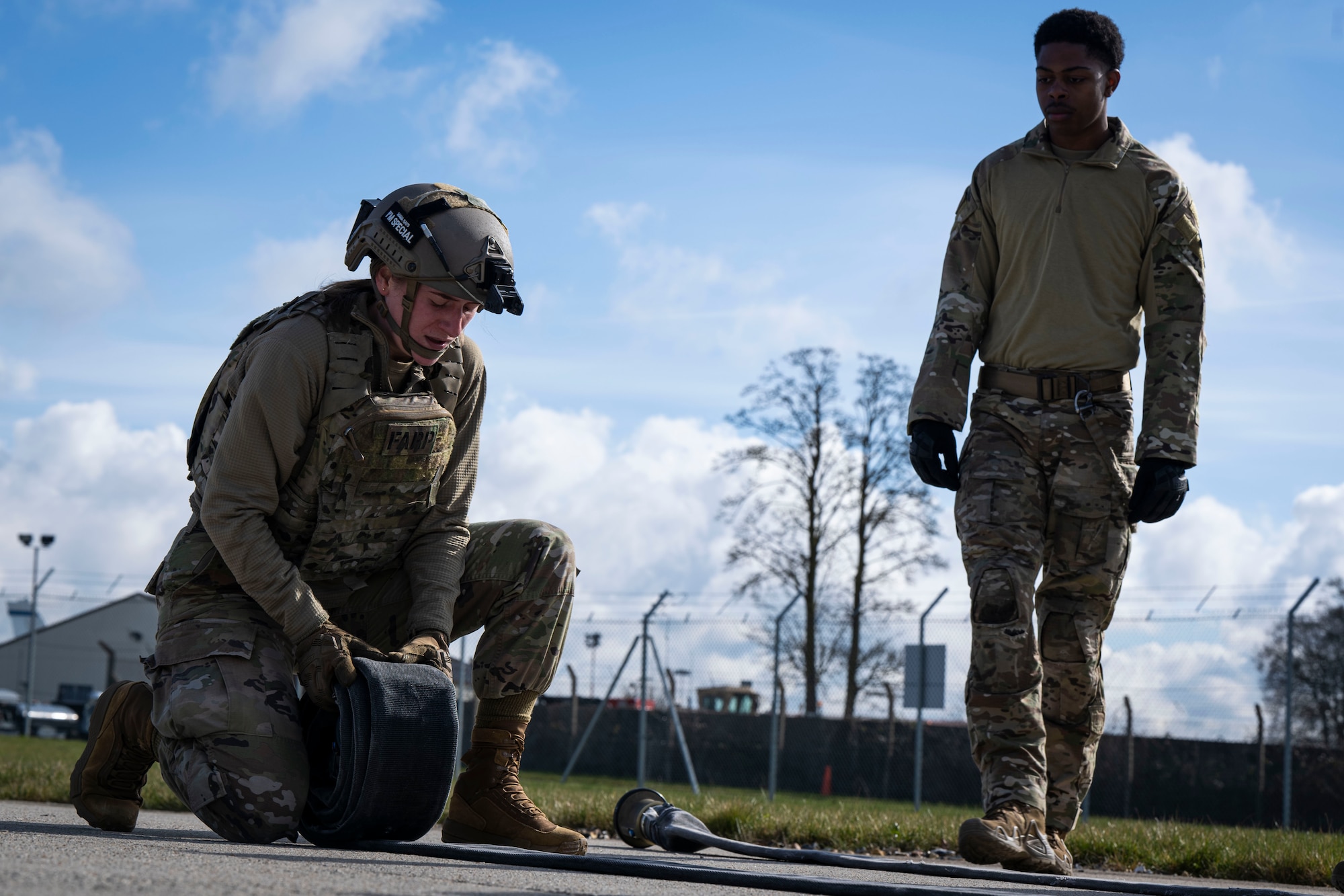 U.S. Air Force 2nd Lt. Claire Stewart, 100th Logistics Readiness Squadron traffic management office officer in charge, rolls a fuel hose during her forward area refueling point team tryout at RAF Mildenhall, England, March 14, 2025.