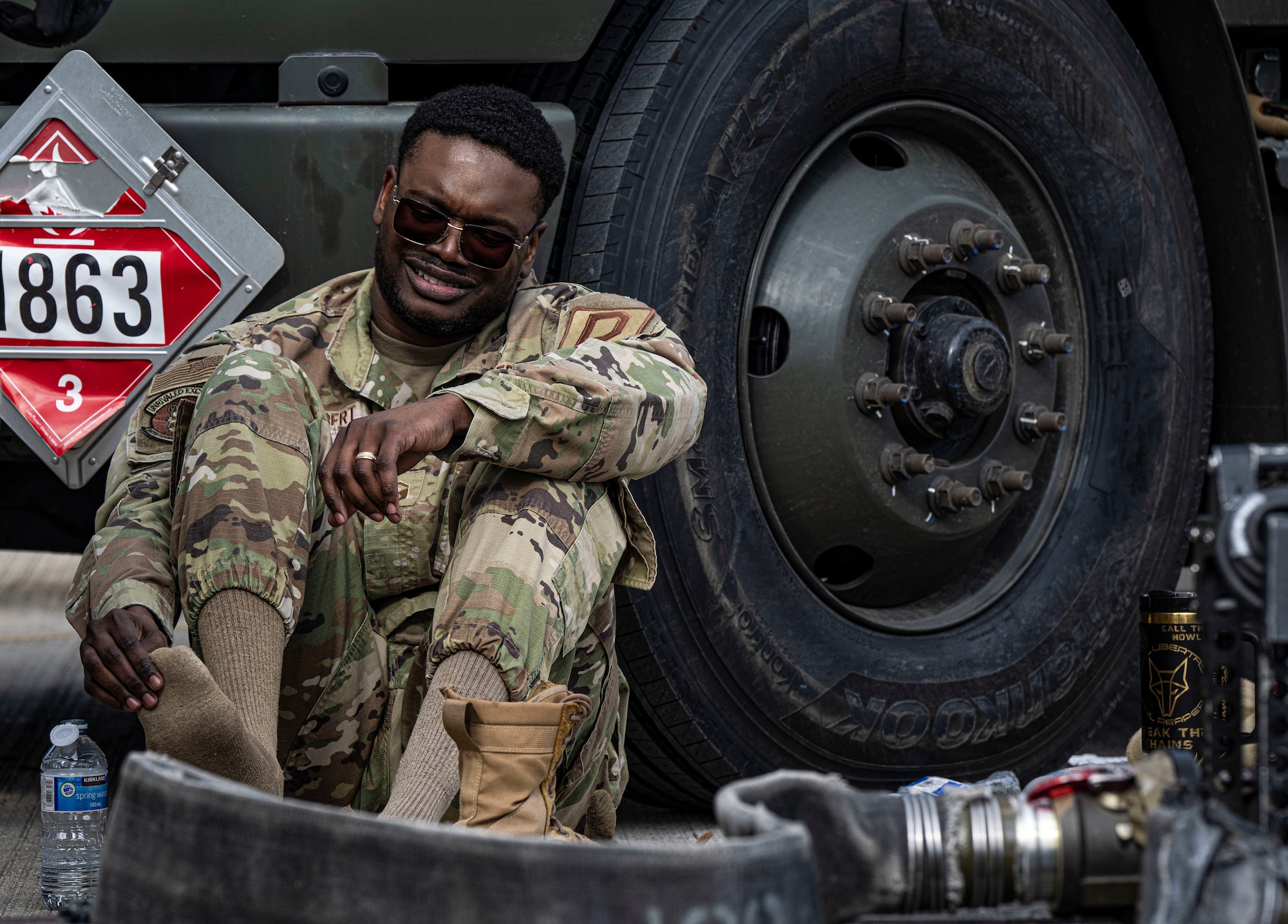 U.S. Air Force Master Sgt. Anthony Gilbert, 100th Logistics Readiness Squadron acting first sergeant, sits against a vehicle after finishing his forward area refueling point team tryout at RAF Mildenhall, England, March 14, 2025.