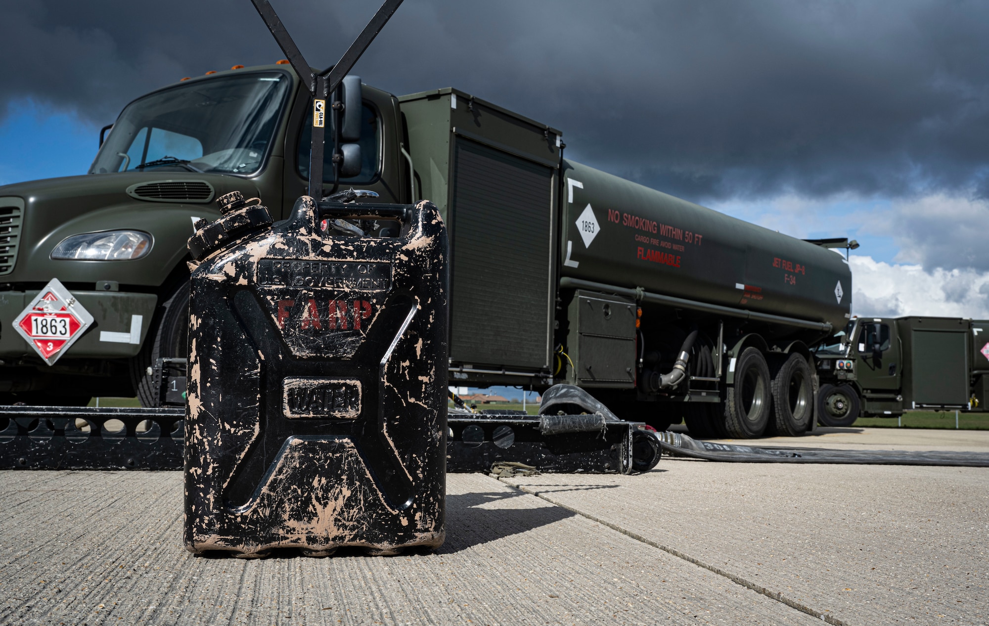 A fuel canister labeled with FARP rests in front of a 100th Logistics Readiness Squadron R-11 fuel truck during forward area refueling point team tryouts at RAF Mildenhall, England, March 14, 2025.