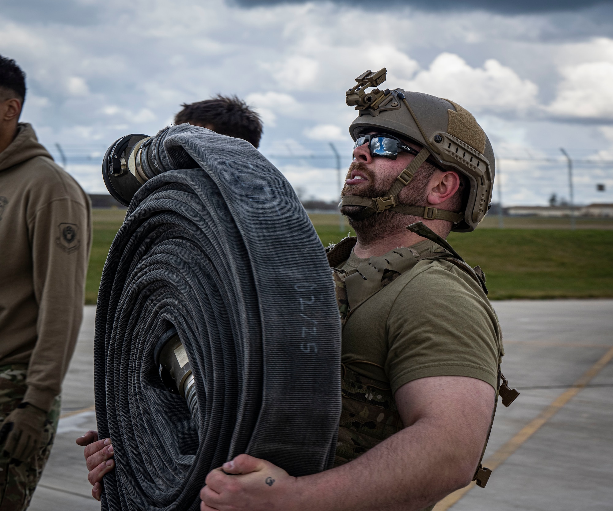 U.S. Air Force Staff Sgt. Marty Ward, 100th Logistics Readiness Squadron vehicle maintenance flight training leader and quality assurance evaluator, carries a fuel hose during his forward area refueling point team tryout at RAF Mildenhall, England, March 14, 2025.