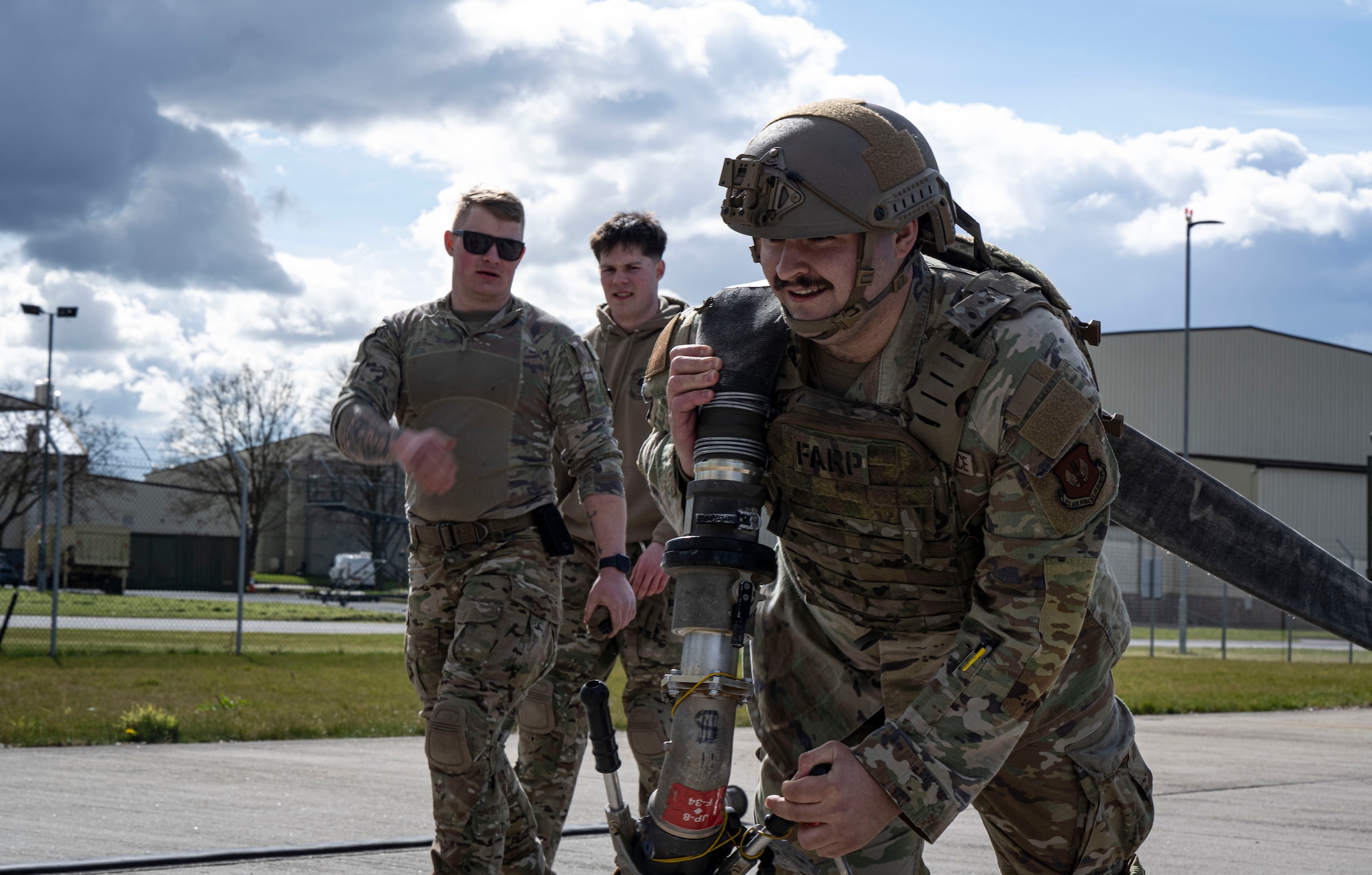 U.S. Air Force Senior Airman Nicholas Spinella, 48th Logistics Readiness Squadron fuels distribution operator, hauls a fuel hose during his forward area refueling point team tryout at RAF Mildenhall, England, March 14, 2025.