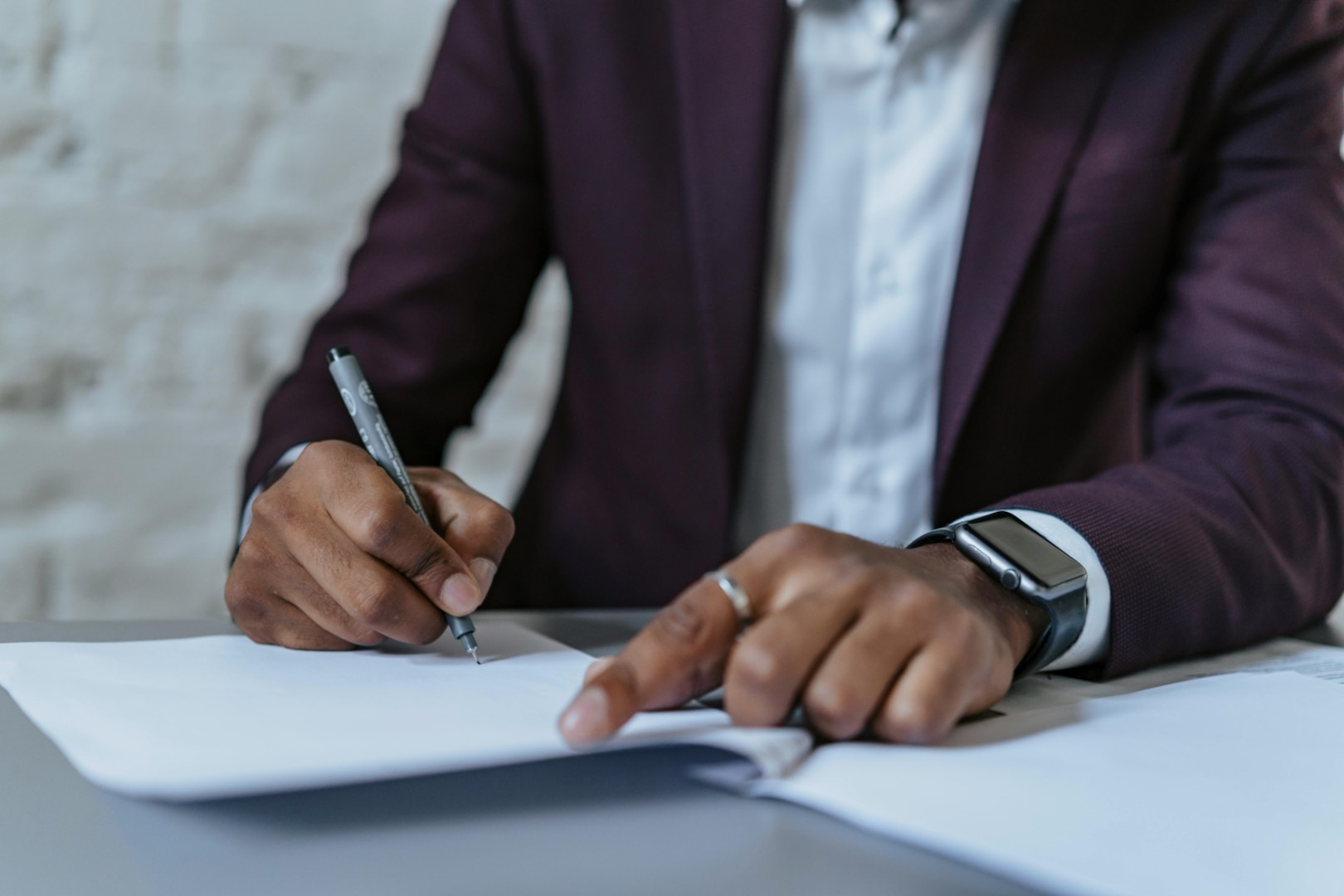 Man signs papers.