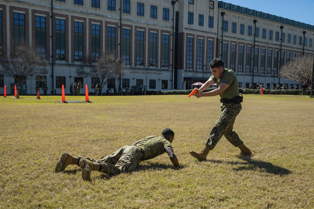 U.S. Marine Corps Cpl. Aaron TorresLemus, combat videographer, Headquarters Battalion, Marine Forces Reserve, commands a simulated suspect to the ground during Security Augmentation Force training, Marine Corps Support Facility, New Orleans, Feb. 26, 2025. Marines experience the effects of pepper spray to learn when to use it appropriately as a method of de-escalation, and to understand how to defend themselves or apprehend suspects. (U.S. Marine Corps photo by Lance Cpl. Van Hoang)