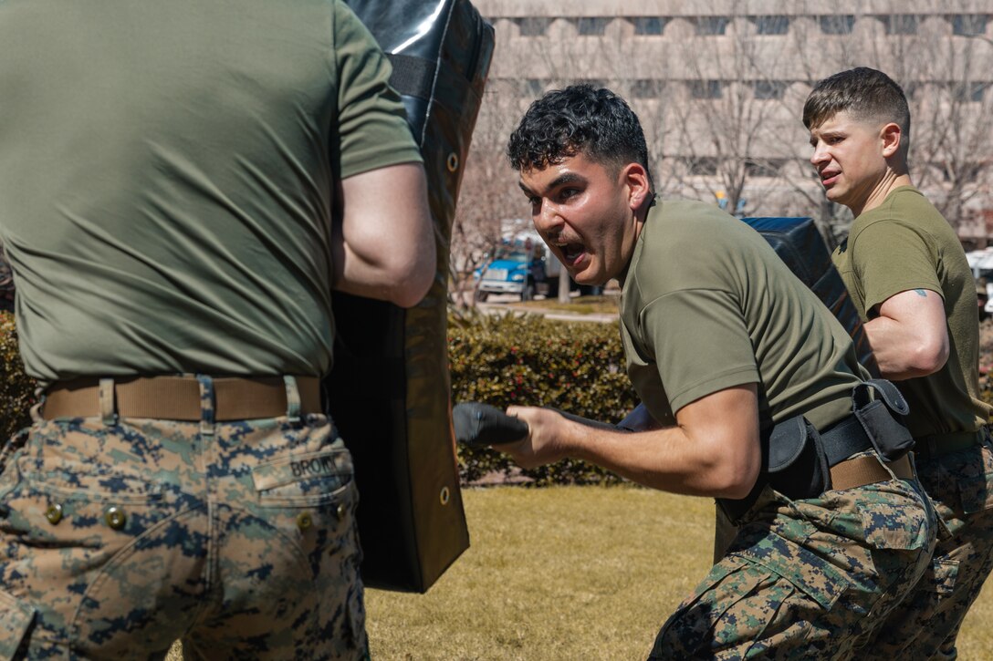 U.S. Marine Corps Cpl. Aaron TorresLemus, combat videographer, Headquarters Battalion, Marine Forces Reserve, uses a baton against simulated enemies Security Augmentation Force training, Marine Corps Support Facility, New Orleans, Feb. 26, 2025. Marines experience the effects of pepper spray to learn when to use it appropriately as a method of de-escalation, and to understand how to defend themselves or apprehend suspects. (U.S. Marine Corps photo by Lance Cpl. Van Hoang)