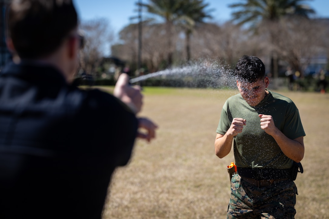 U.S. Marine Corps Cpl. Aaron TorresLemus, combat videographer, Headquarters Battalion, Marine Forces Reserve, gets pepper sprayed during Security Augmentation Force training, Marine Corps Support Facility, New Orleans, Feb. 26, 2025. Marines experience the effects of pepper spray to learn when to use it appropriately as a method of de-escalation, and to understand how to defend themselves or apprehend suspects. (U.S. Marine Corps photo by Sgt. Scott Jenkins)