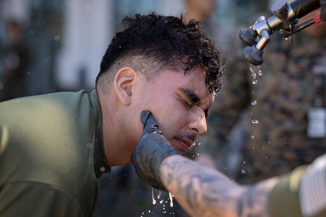 U.S. Marine Corps Cpl. Aaron TorresLemus, combat videographer, Headquarters Battalion, Marine Forces Reserve, decontaminates after completing Security Augmentation Force training, Marine Corps Support Facility, New Orleans, Feb. 26, 2025. Marines experience the effects of pepper spray to learn when to use it appropriately as a method of de-escalation, and to understand how to defend themselves or apprehend suspects. (U.S. Marine Corps photo by Sgt. Scott Jenkins)