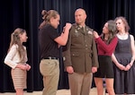 From left, Lena Beard, Max Beard, Kaiona Weber and Mali’a Weber, children of newly promoted Lt. Col. Jacob Beard, officer-in-charge, 404th Maneuver Enhancement Brigade, pin his new rank on during a promotion ceremony March 15 at Heartland Community College in Normal, Illinois. (U.S. Army photo by Maj. Kanesha Newport)