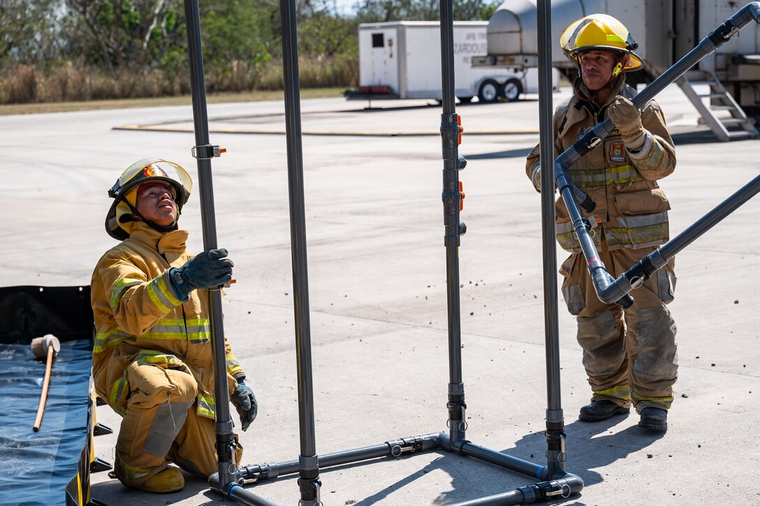 Local Honduran firefighters build a decontamination shower during a hazmat exercise led by Joint Task Force-Bravo firefighters at Soto Cano Air Base, Honduras, March 14, 2025.