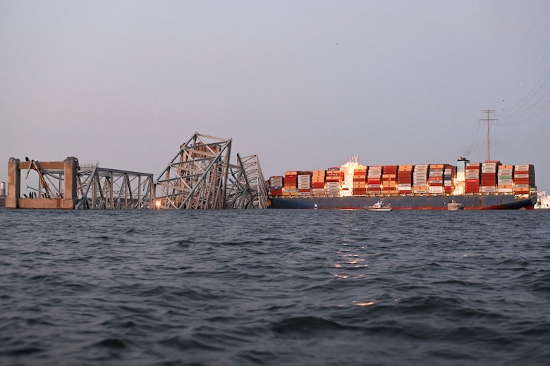 cargo ship and collapsed bridge in water