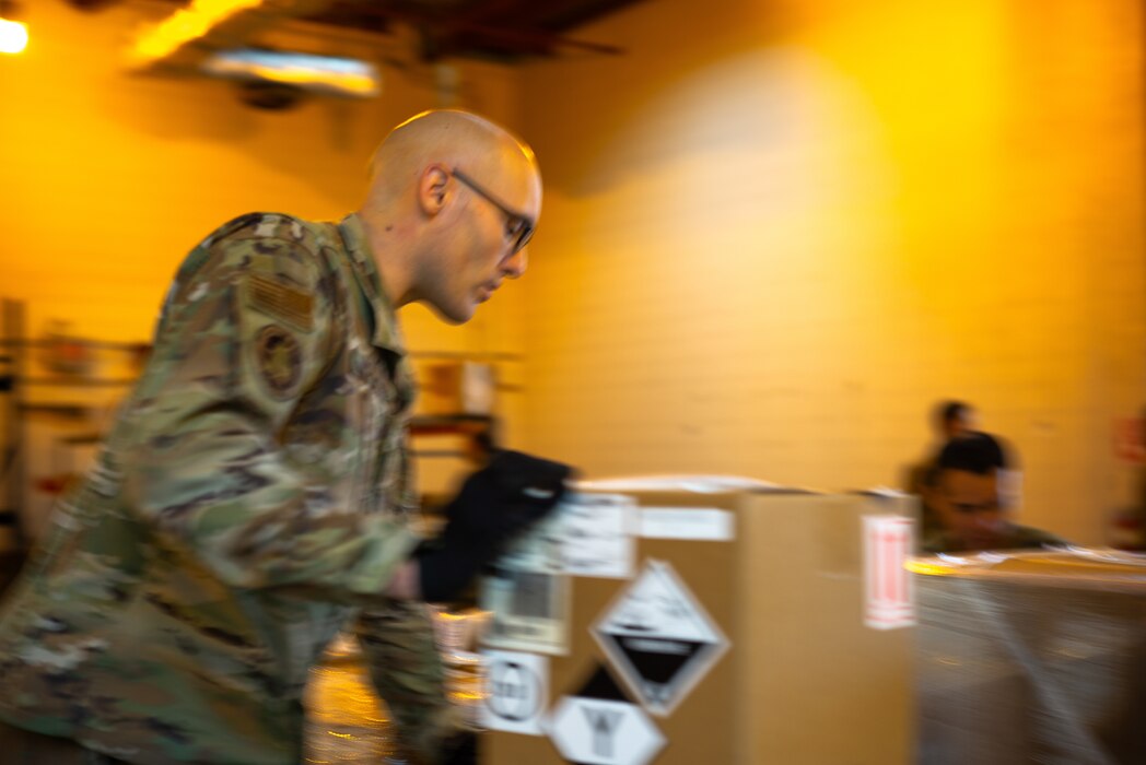Tech. Sgt. Duncan Hamlin, a loadmaster with the 86th Aerial Port Squadron, performs cargo inspections prior a forklift move on Dec. 12, 2024, at Travis Air Force Base, California. The 86th APS is responsible for global airlift operations.