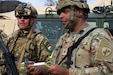 Hohenfels, Germany - U.S. Army Reserve Sgt. Ashwin Tewari, a psychological operations non-commissioned officer, 351st Psychological Operations Company, (right) shares information related to convoy operations with Senior Warrant Officer Sandor Zadravecz, Hungarian Defense Forces (HDF) Civil-Military Cooperation, (left) during Exercise Allied Spirit 25 here on March 10, 2025. Allied Spirit 25 is a training exercise that uses real-world scenarios to train U.S. Army Reserve soldiers and Multinational Partner Forces.  (U.S. Army Reserve photo by Staff Sgt. Emilie Lenglain/Released)