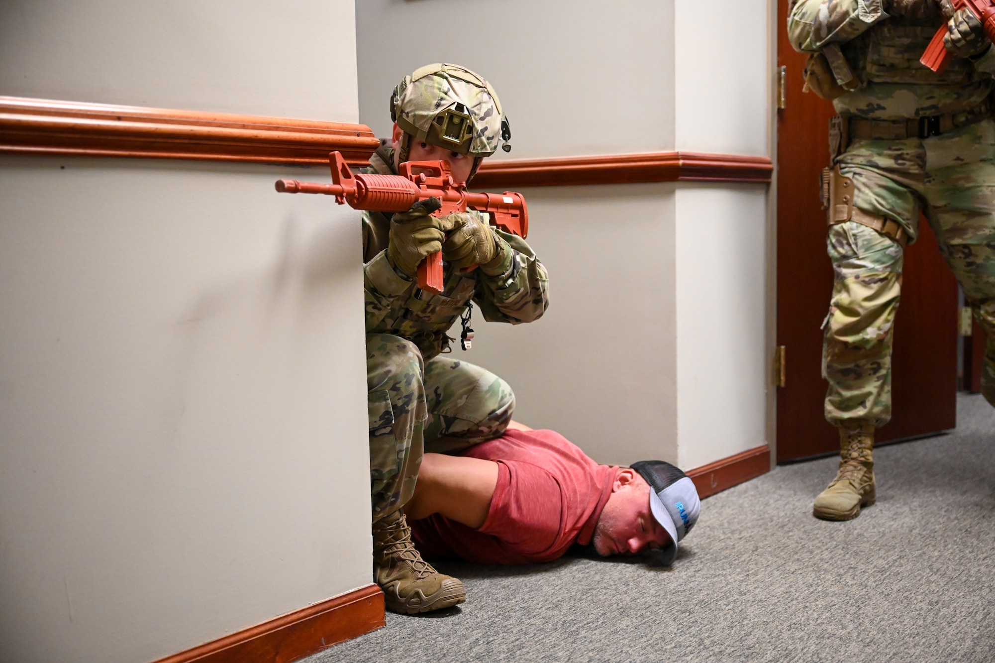 U.S. Air Force Technical Sgt. Michael Watkins, flight sergeant for the 11th Security Forces Squadron at Joint Base Anacostia-Bolling subdues Dylan Myers, flight sergeant for the 11th security force squadron while roleplaying an active shooter scenario during a combat readiness exercise on JBAB, March 11, 2025. The exercise tested the base’s mission readiness and capabilities during an active shooter drill. (U.S. Air Force photo by Airman 1st Class Shanel Toussaint)