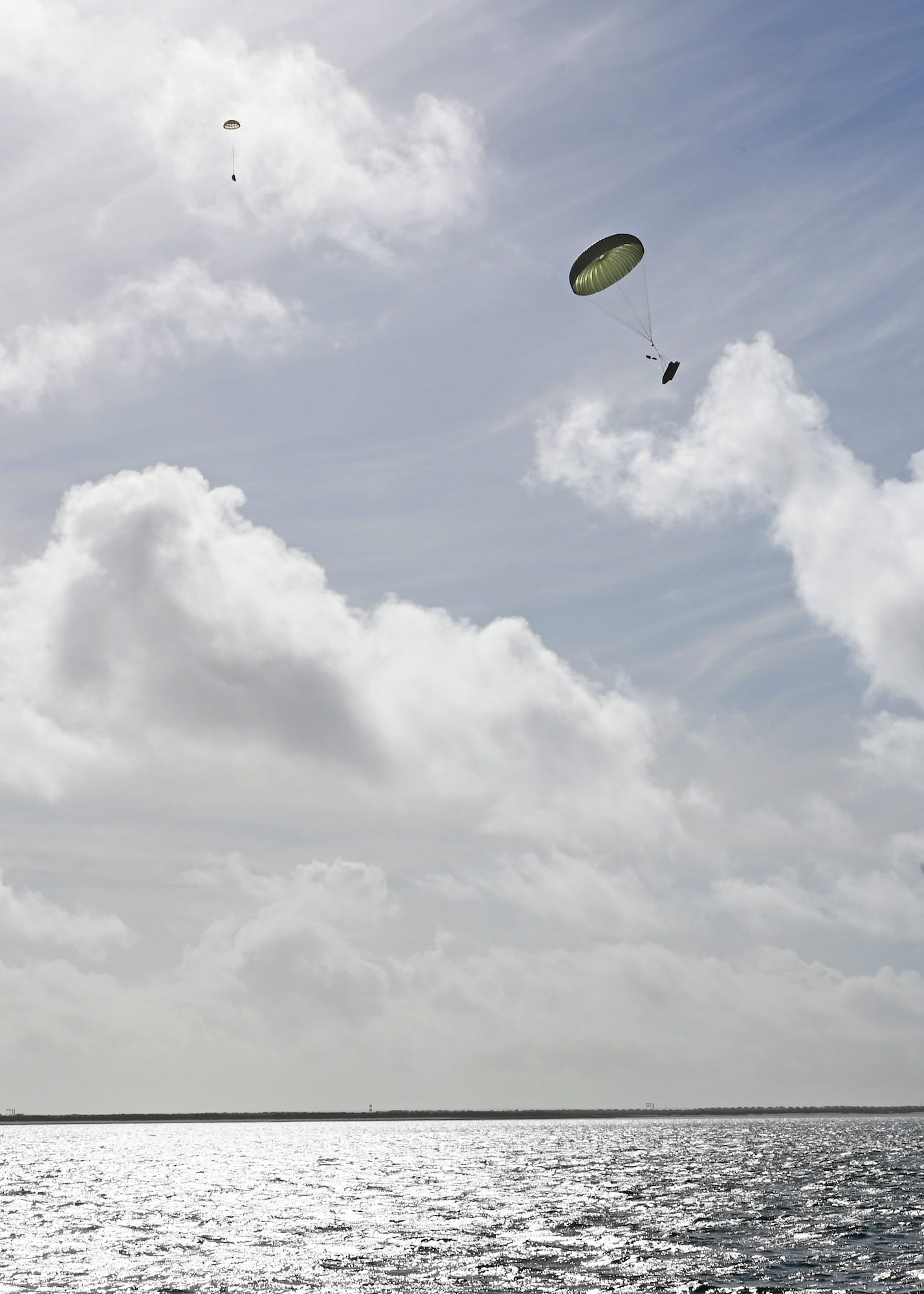 Rescue supplies airdrop into the landing zone during a water rescue scenario for Exercise Bamboo Eagle 25-1, in the San Diego Bay, California, Feb. 14, 2025. BE tested U.S. Air Force capabilities within the joint multi-domain environment to achieve operational objectives through tactical execution designed by the 414th Combat Training Squadron at Davis-Monthan Air Force Base, Arizona. (U.S. Air Force photo by Staff Sgt. Abbey Rieves)