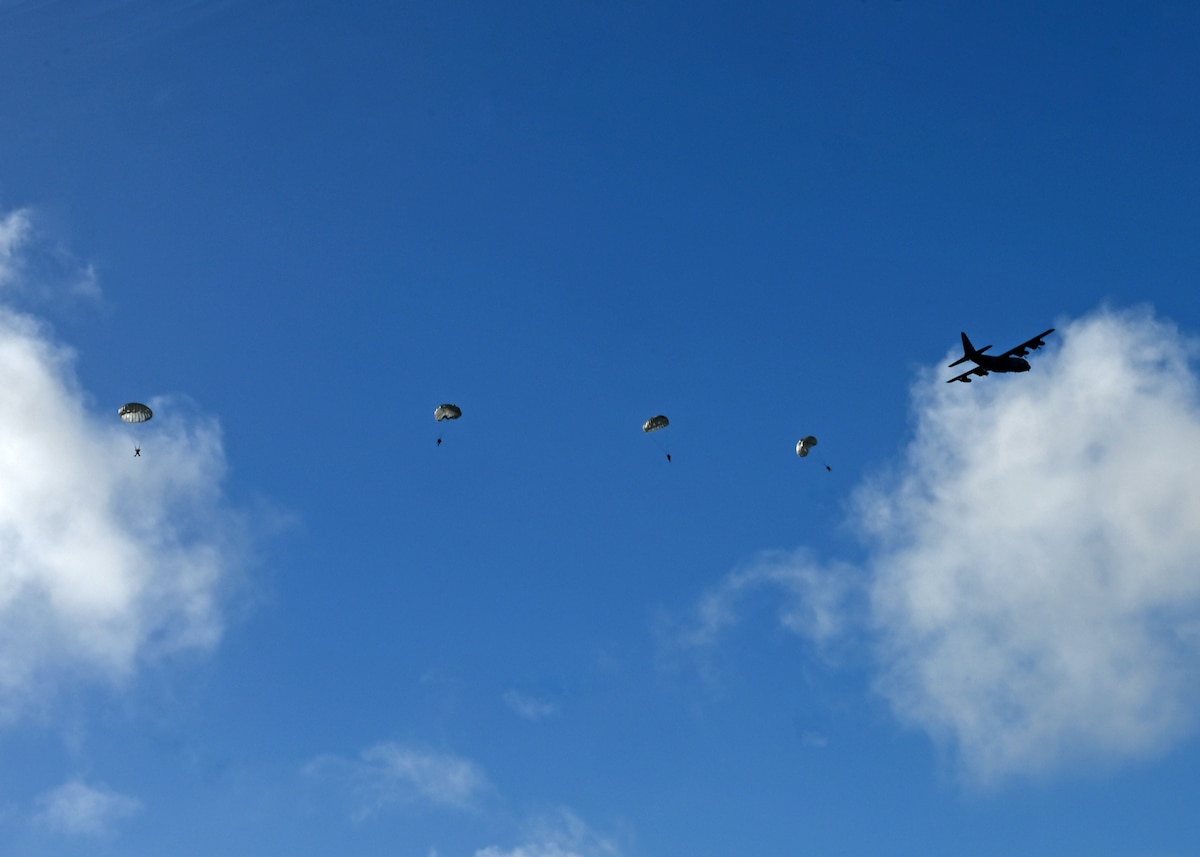 An HC-130J Combat King II aircraft assigned to the 71st Rescue Squadron airdrops pararescuemen into a landing zone for Exercise Bamboo Eagle 25-1, in the San Diego Bay, California, Feb. 14, 2025. PJs were dropped to rescue, triage and treat isolated personnel who were injured during a simulated aircraft crash scenario. The 414th Combat Training Squadron Detachment 1, based at Davis-Monthan Air Force Base in Arizona, organized search and recovery safety protocols for joint service members participating in combat-scenario training. (U.S. Air Force photo by Staff Sgt. Abbey Rieves)