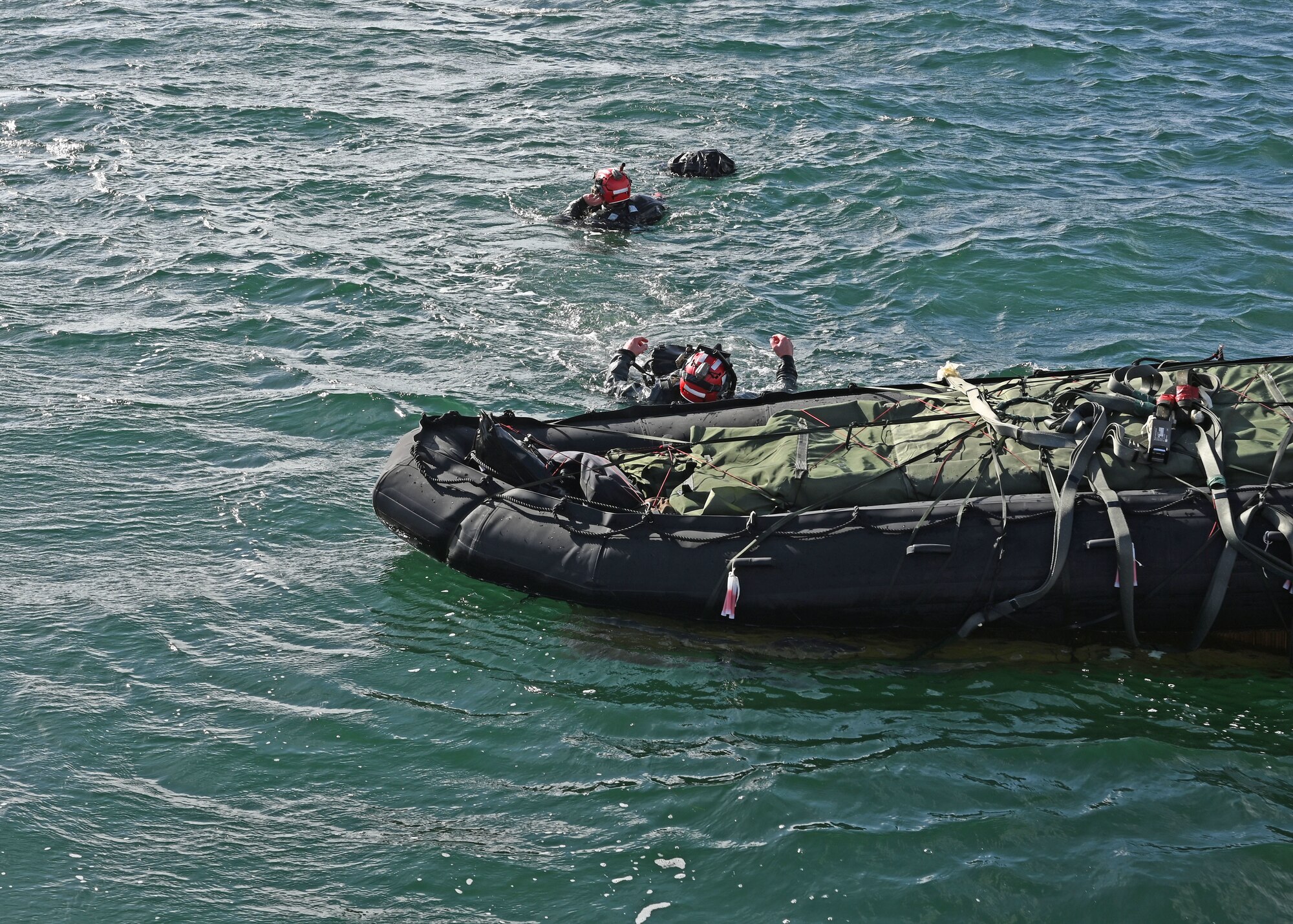 U.S. Airmen assigned to the 38th Rescue Squadron swim to their rescue supplies during Exercise Bamboo Eagle 25-1, in the San Diego Bay, California, Feb. 14, 2025. Bamboo Eagle is a U.S. Air Force Warfare Center exercise that builds upon the tactical expertise exercised in previous exercises and presents participants with opportunities to address challenges associated with mission generation and command and control in a contested environment. (U.S. Air Force photo by Staff Sgt. Abbey Rieves)