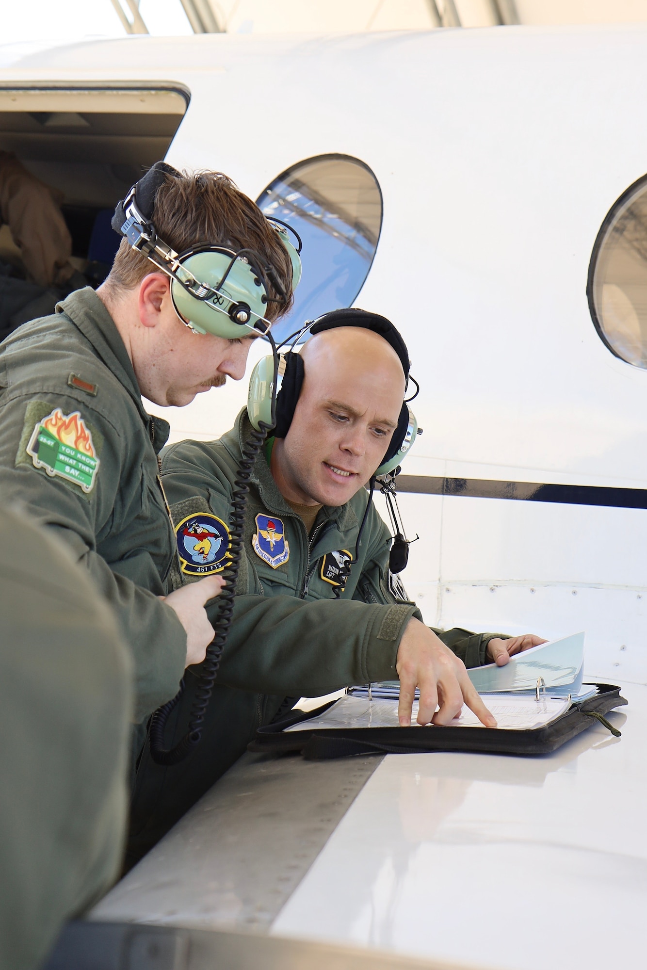 U.S. Air Force Captain Nathan Hallam, 479th Flying Training Group combat systems operator instructor, teaches 2nd Lieutenant John Chambers, 479th FTG CSO student, during the advance phase of training March 5, 2025, at Naval Air Station Pensacola, Florida.