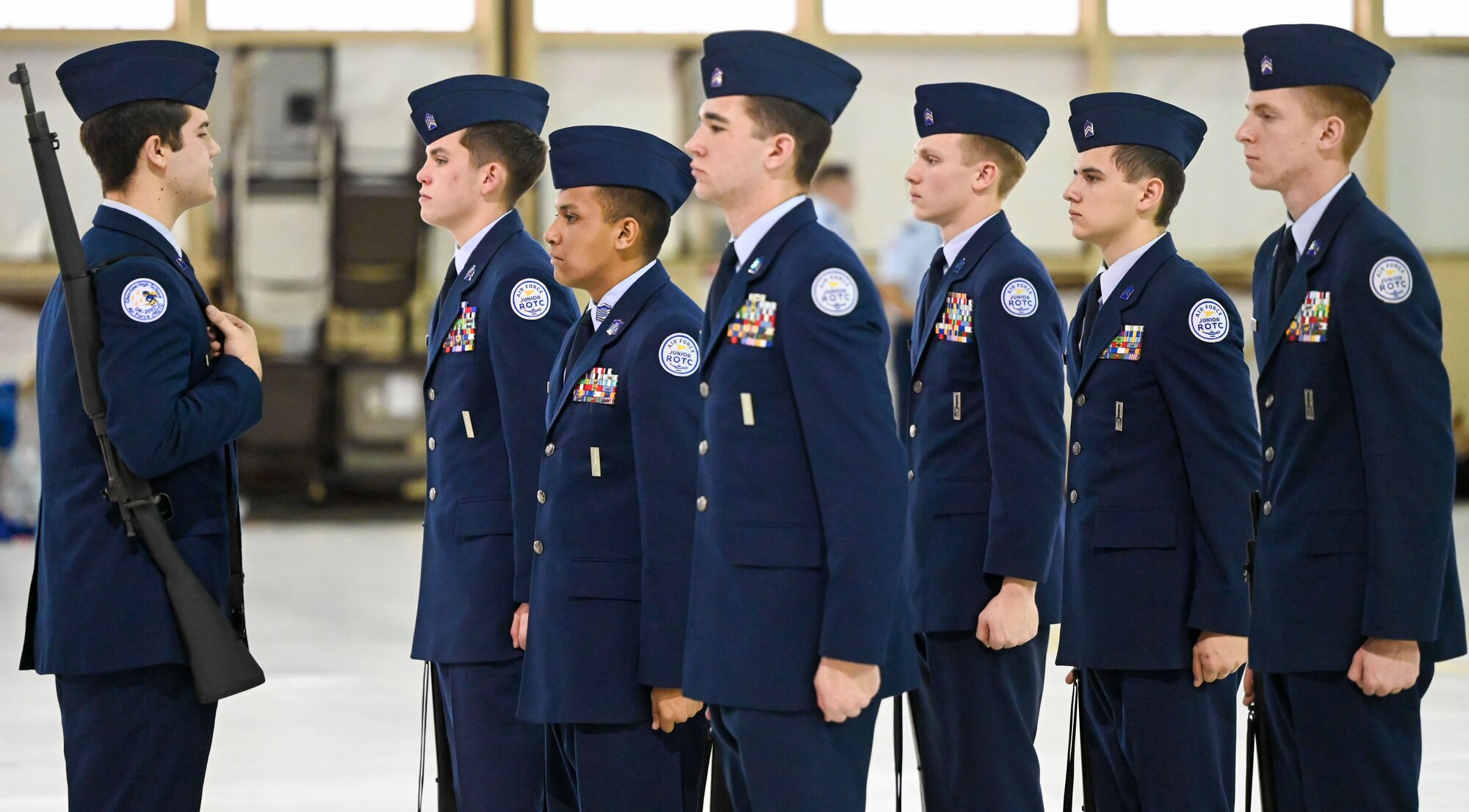 Junior Reserve Officers' Training Corps (JROTC) cadets stand at attention during an inspection at the JROTC Drill Competition at Tinker Air Force Base, Oklahoma, Feb. 15, 2024. The competition, returning to base after more than 20 years, featured precision drill routines, color guard performances, and exhibition drills. (U.S. Air Force photo by Garrett N. Cole)